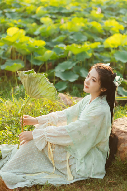 istock A Hanfu beauty playing outdoors by the lotus pond in summer 2170193820
