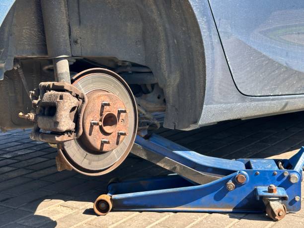 istock Car Jack Lifting for Tire Wheel Replacement Service - Closeup. 2170196097