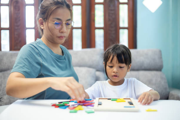 istock A woman and a child are playing with a puzzle 2170198159