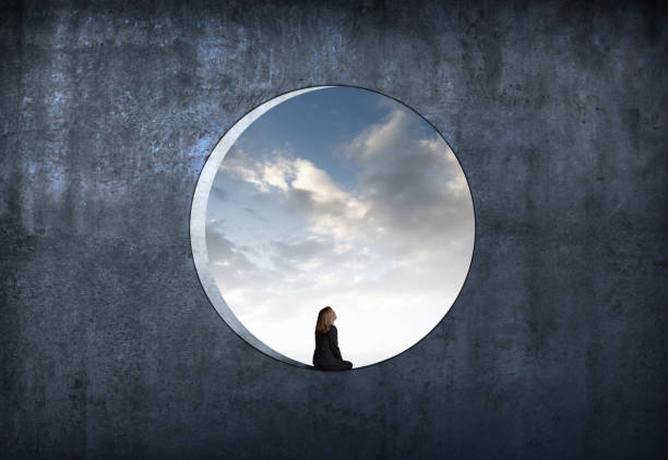 istock Woman Sitting In Large Circular Window 2170201314