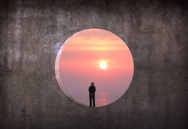istock Woman Standing In Large Circular Window 2170201318