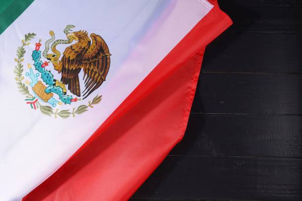 istock Waving Mexican flag draped on dark wooden surface with vibrant colors, symbolizing national pride and heritage, captured during daytime 2170201321