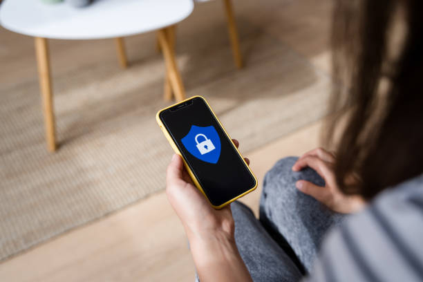 istock Woman holding smartphone showing security application on screen 2170202648