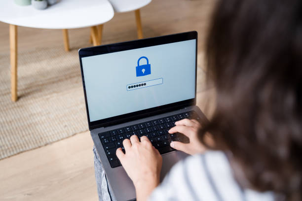 istock Woman typing password on laptop with padlock icon on screen 2170202671