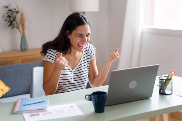 istock Excited woman celebrating success while working from home 2170202897