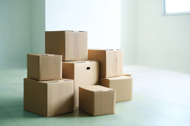 istock Packed cardboard boxes placed in a large room or office 2170203665