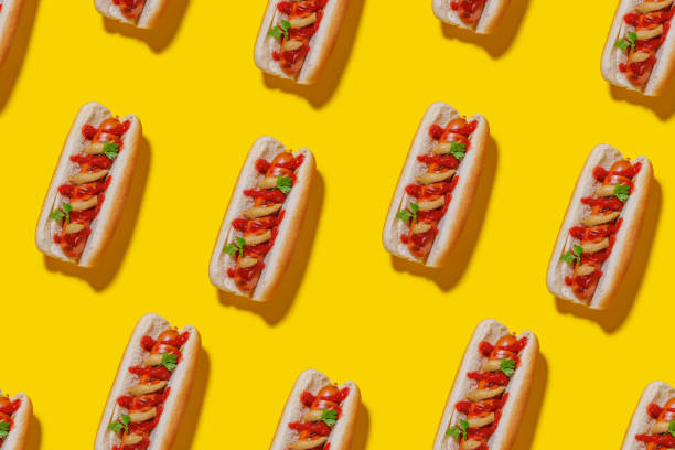 istock A seamless, eye-catching pattern featuring hot dogs arranged across a bright yellow background 2170205002