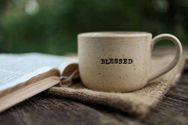 istock Cup with text BLESSED and open Bible in the garden, good morning 2170205329