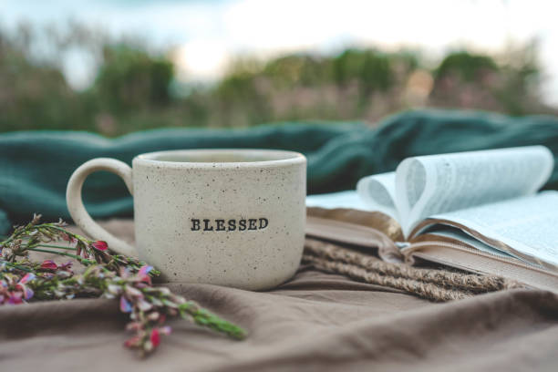 istock Cup with text BLESSED and open Bible in the garden, good morning 2170205336