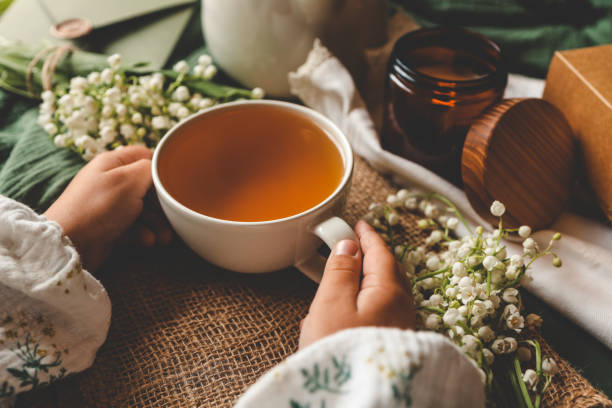 istock Cup of herbal tea in hands, spring atmosphere mood 2170205780