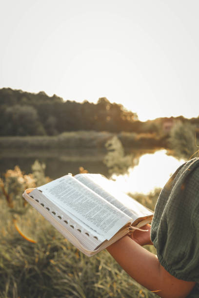 istock Girl with an open Bible in her hands, summer mood 2170207086