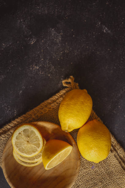 istock Fresh and juicy lemon on a dark rustic background 2170207092