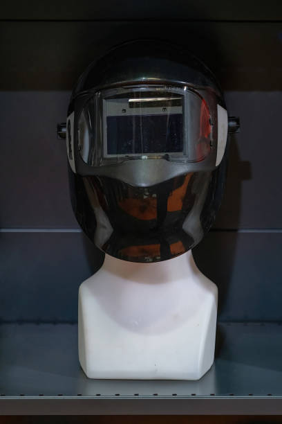 istock A mannequin wearing a modern welding helmet with a reflective visor in a brightly lit industrial environment. The helmet features advanced design elements, emphasizing safety and technology. 2170207761