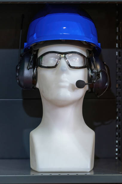 A mannequin equipped with essential safety gear, including a blue hard hat, ear protection, and tinted safety glasses. Ideal for showcasing construction or industrial safety equipment.