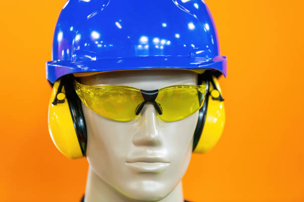 A mannequin equipped with essential safety gear, including a blue hard hat, yellow ear protection, and tinted safety glasses. Ideal for showcasing construction or industrial safety equipment.