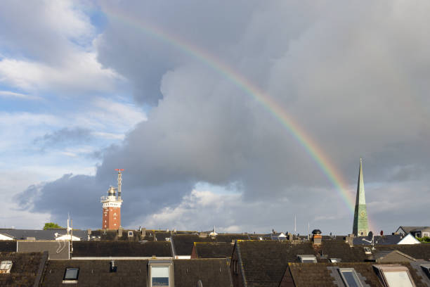 Cloudy sky above German Helgoland village with beautiful rainbow