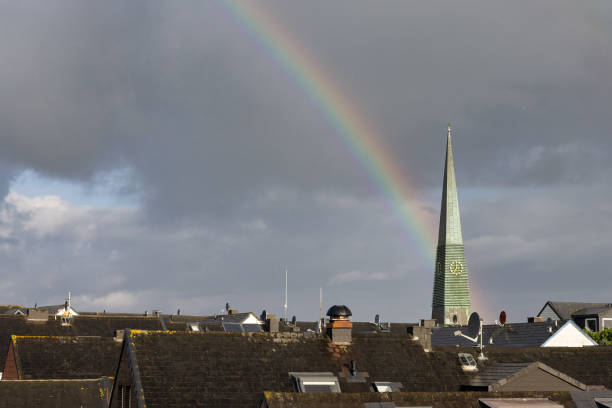 Cloudy sky above German Helgoland village with beautiful rainbow