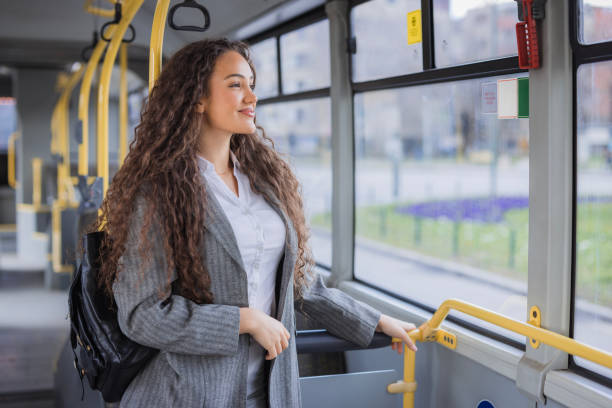 istock Girl standing in a bus and looking through the window 2170209576