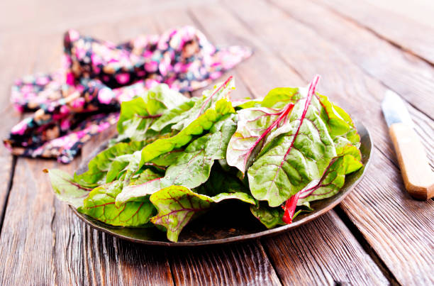 istock Salad leaves. Raw green leaf vegetables. Mangold leaves on plate 2170209793