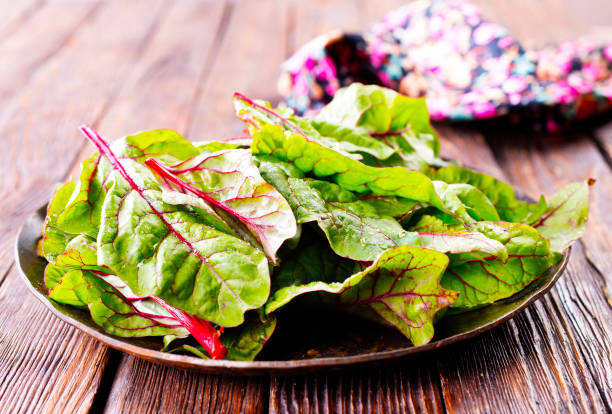 istock Salad leaves. Raw green leaf vegetables. Mangold leaves on plate 2170209806