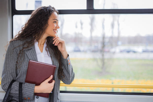 istock Happy female student observing surroundings through the bus window 2170209828