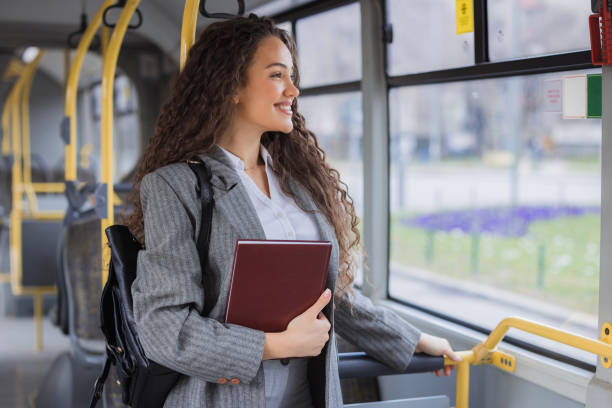 istock Girl smiling when holding a book and looking through the bus window 2170209961