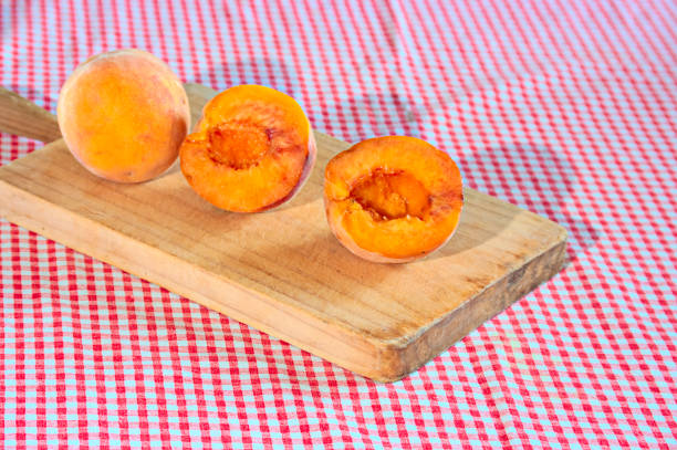Fresh peach slices arranged on a plate, providing a healthy snack for a student working on their studies