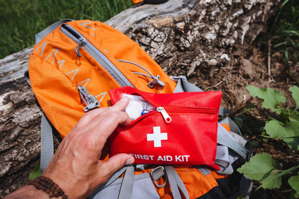 istock In the natural environment, a person with an orange backpack and first aid kit connects strongly with nature, prioritizing travel and safety measures during their journey 2170223563