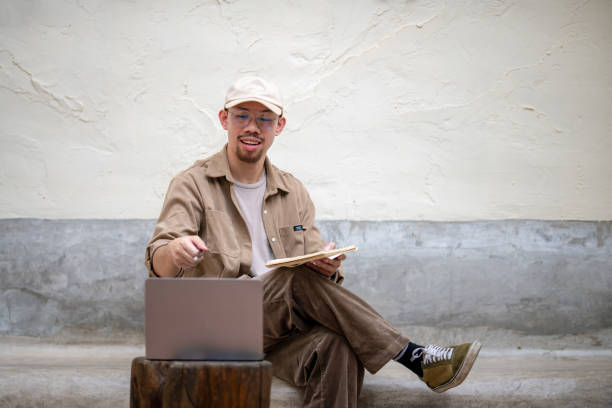 istock Freelance man in a cap doing video call on laptop online conference 2170225330