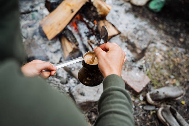 istock Experience the tranquil ritual of brewing coffee outdoors by a campfire in nature as part of your morning routine, enjoying the aromas and coziness of this rustic ritual 2170226811
