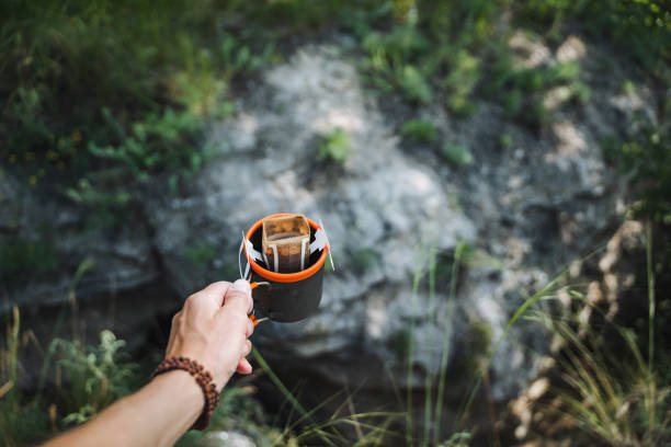 istock In the peaceful outdoors, find tranquility holding an enamel cup and leather wallet, surrounded by wild beauty. Enjoy nature while exploring the serene wilderness 2170226827