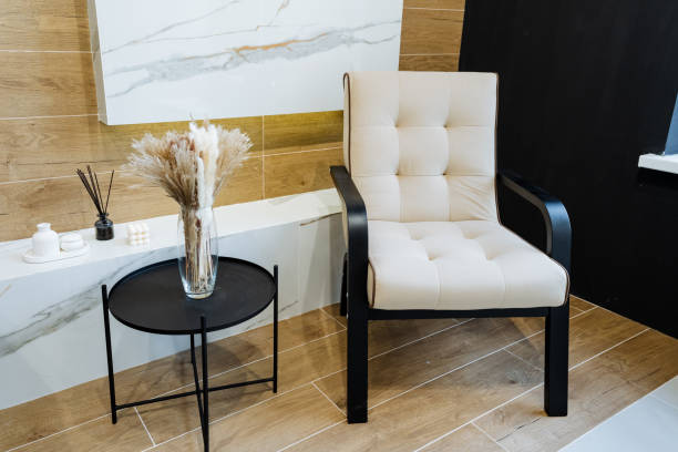 istock This contemporary living space features a beige armchair and black side table, offering a stylish and sophisticated ambiance for an elegant and cozy interior design 2170227311