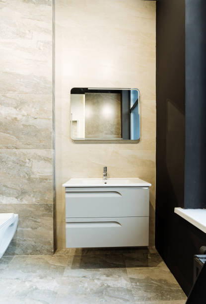 istock The bathroom is equipped with a sink, toilet, and mirror. It might also include cabinetry, bathroom cabinet, and furniture. The building features wood floors, drawers, and hardwood flooring 2170227316