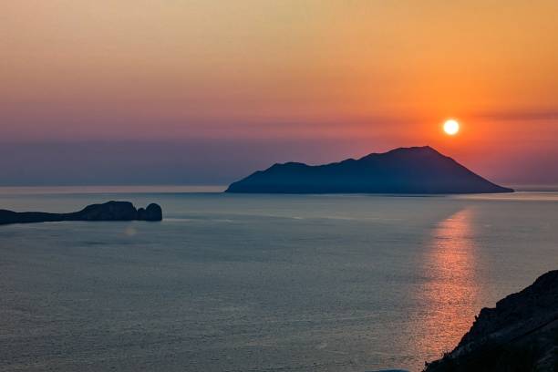 Sunset view from Milos island, with a sea landscape and the sun over Antimilos
