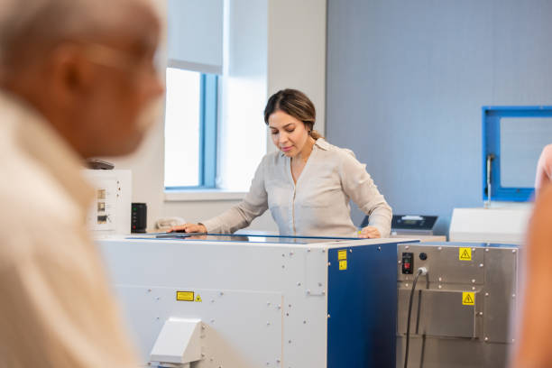 istock Woman uses laser engraver machine in STEM workshop makerspace 2170228688