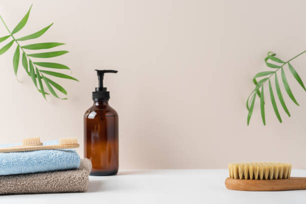 istock Stack of terry towels, brown recycled glass bottle with soap dispenser on white background 2170229094