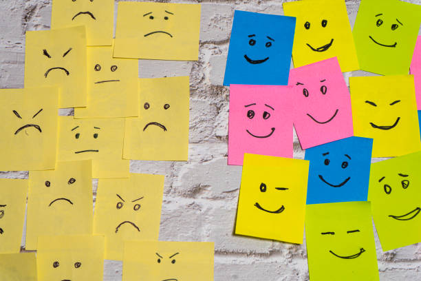 istock conceptual image composed of two groups of post-its facing each other and showing different emotions. 2170229196