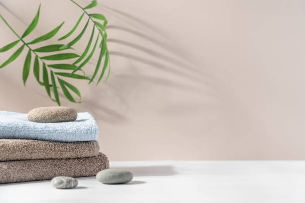 istock Stack of terry towels on light background with tropical plants 2170232355