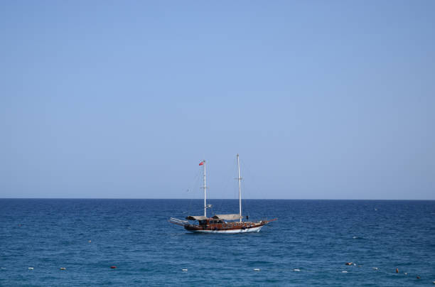 Boat on calm sea water near coast. Tourist boat. Antalya region, Turkey.