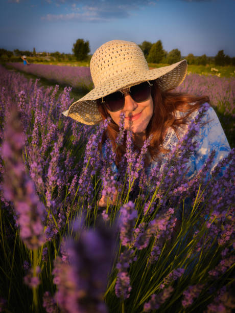 istock Lady in Blue Enjoying Lavender at Sunset 2170237372