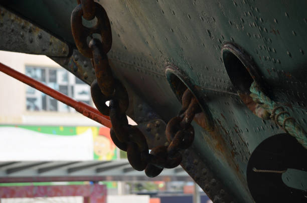 A close-up photo of a ship anchor chain. An anchor chain is a crucial component of a ship’s anchoring system. It connects the anchor to the vessel and ensures that the anchor can hold the ship in place. They are typically made of high-strength steel to withstand the harsh marine environment. anchor chain stock pictures, royalty-free photos & images