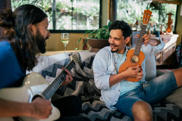 istock Two young men playing guitar together at home 2170245335
