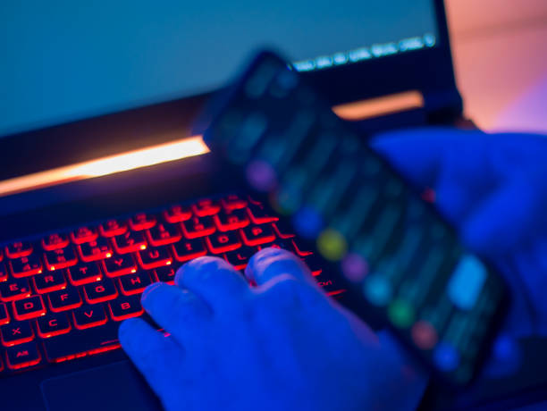 istock A person manipulating a mobile phone and a laptop 2170248265