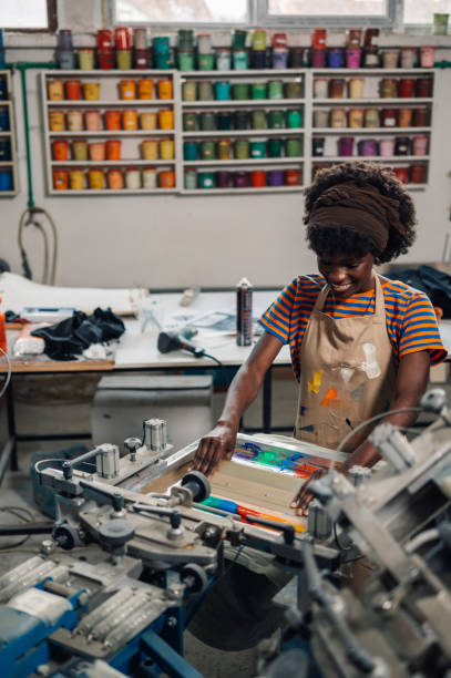 istock Portrait of diverse print shop worker using squeegee for screen printing 2170248911
