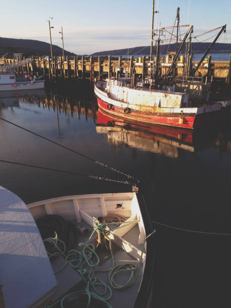 Fishing boats docked at a village wharf.