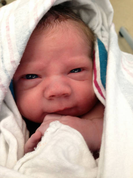 A baby boy is wrapped in a blanket just moments after birth.