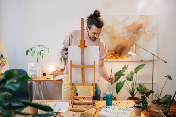 istock Young talented trendy painter painting on easel at creative art studio 2170251856