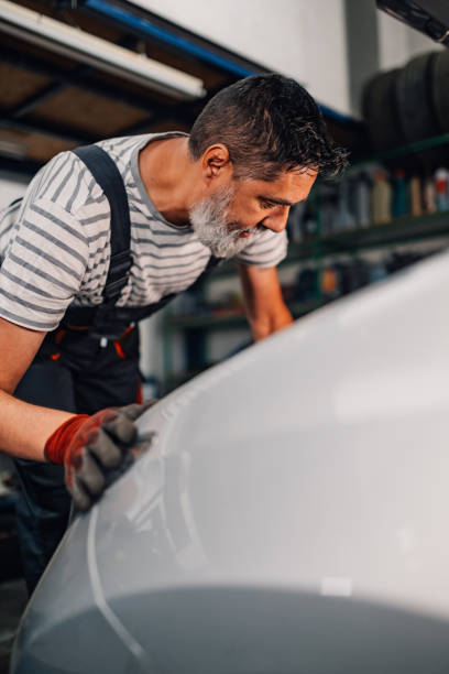 istock Professional auto mechanic fixing car at mechanic workshop. 2170252148