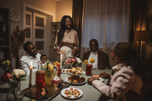 Family Dinner Party Happy African American multi-generation family having dinner reunion, talking and having fun big family table stock pictures, royalty-free photos & images