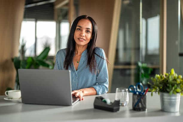 istock Confident Hispanic Businesswoman in Office Setting 2170259141